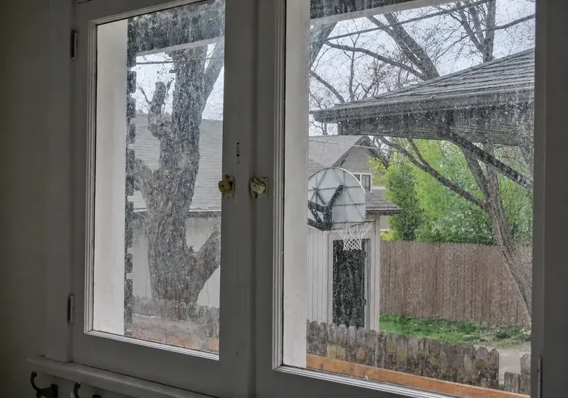 Dirty residential window glass viewed from indoors