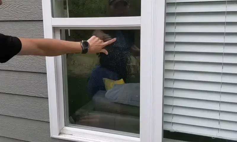 Hard water spots being removed from window glass