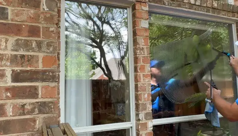 Paint overspray droplets on window glass before removal