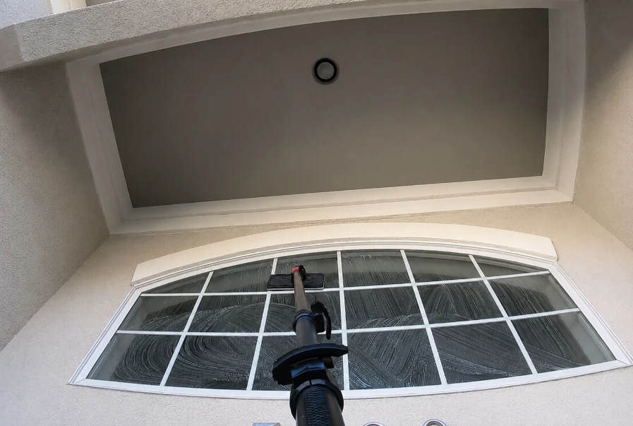 Residential arched window receiving a detailed first cleaning