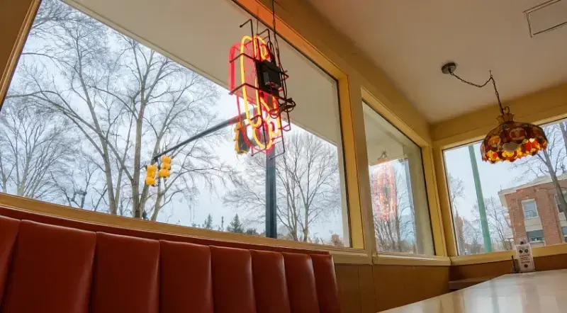 Large restaurant windows viewed from an occupied dining area